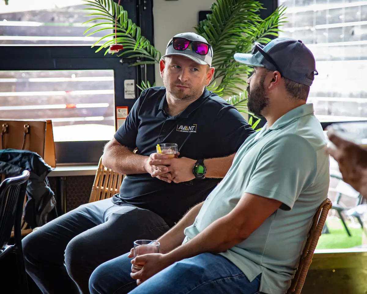 Two Avant team members talking outdoors