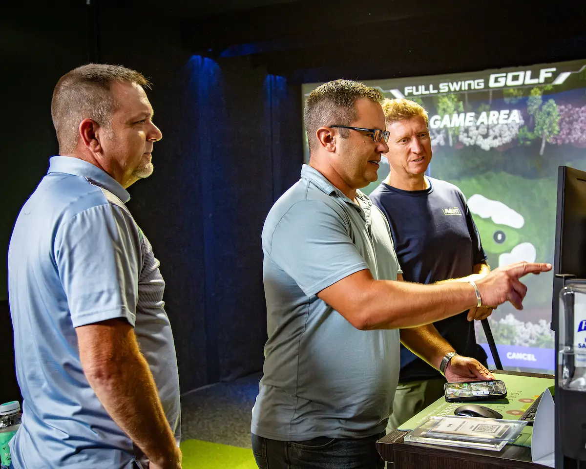 Avant team members at a golf simulator